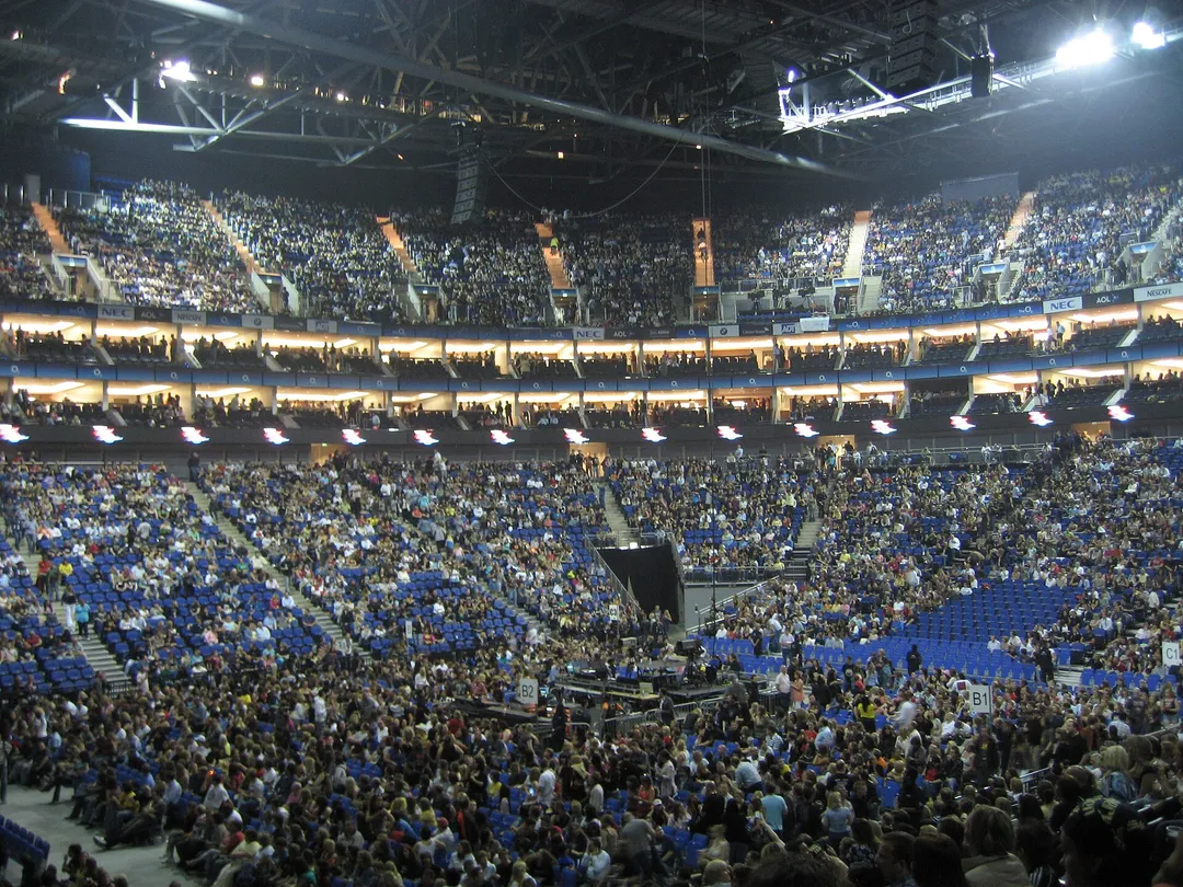 The inside of The O2 arena in London: tiers of seats rising steeply around the arena floor.